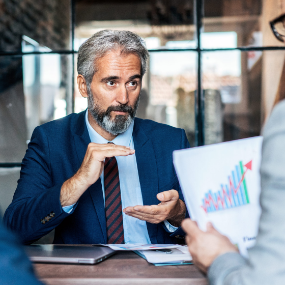 Financial professional discussing market challenges with client. 