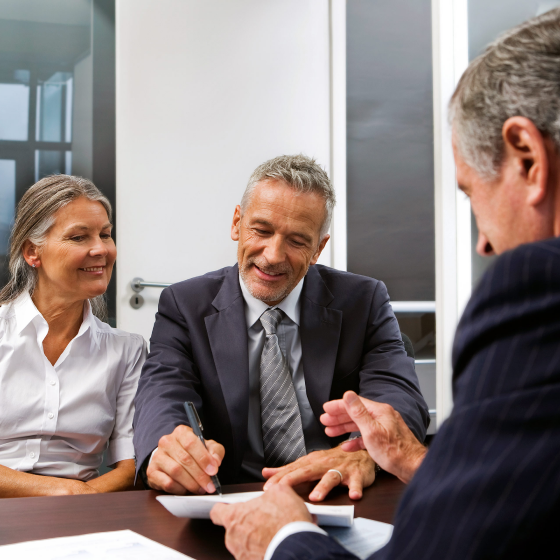 Financial professional helping clients understand risks to retirement. 