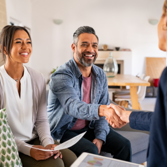 A financial professional showing a retired husband and wife the benefits of term life insurance