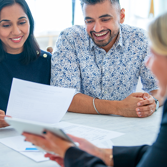 A financial professional explains to a couple how they can build a legacy with whole life insurance.