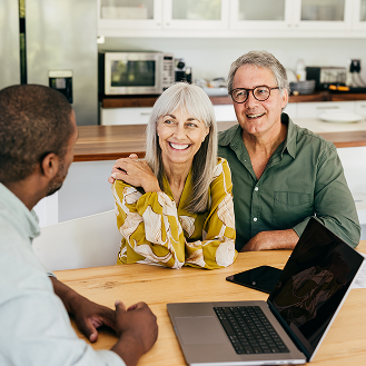 An older couple discuss non-participating life insurance with a financial professional.