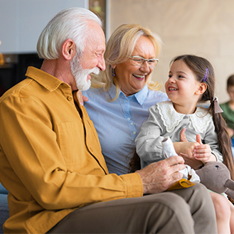 Retired couple enjoying quality time with their granddaughter.