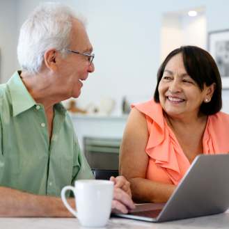 A couple discussing their reliable income stream from an immediate annuity.