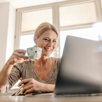 Woman using her laptop to research information on cost effective fixed annuities