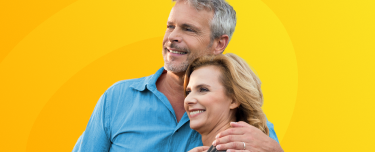 A retired couple smiling.