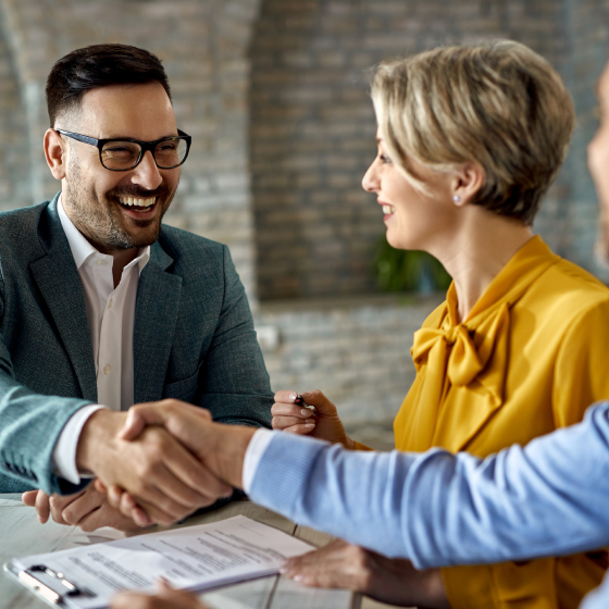 Financial professional shaking hands with customers who just purchased a variable annuity.