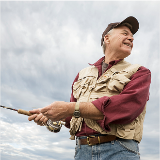 A man smiling while fishing, knowing he is protected with whole life insurance.