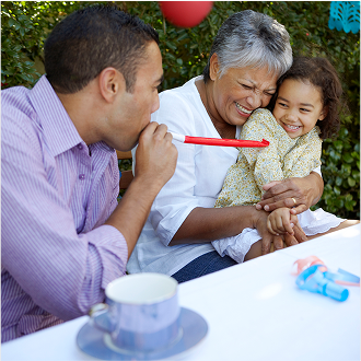 A grandmother celebrating their granddaughter's birthday, knowing her family is protected with Protective Lifetime Assurance universal life insurance.
