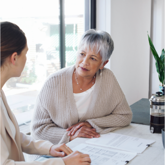 A financial professional meeting with a woman about retirement planning.