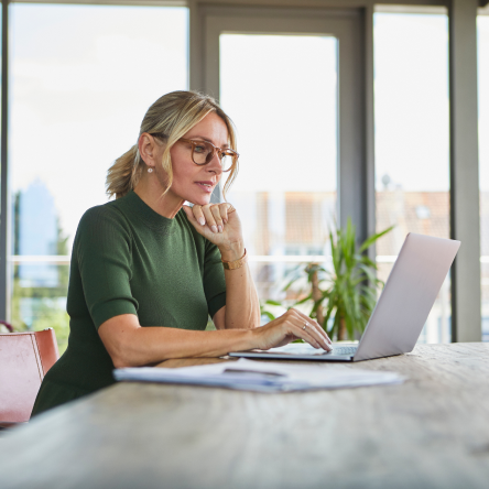 Woman using a laptop to read about Protective® Aspirations variable annuity.