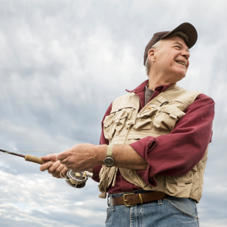 A man enjoying a fishing trip knowing he's protected with whole life insurance.