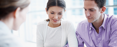 Financial professional discussing life insurance with existing P&C customers.