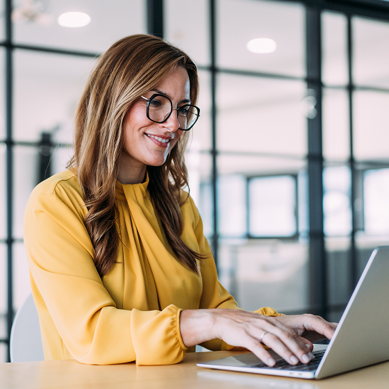 Female financial professional viewing interest rates on a laptop.