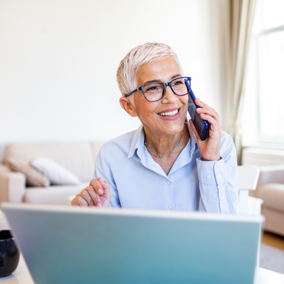 A retired woman talking to her financial professional on the phone about Protective Non-Participating Whole Life