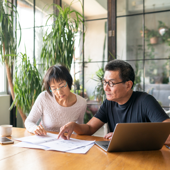 A husband and wife reviewing the features of Protective Series Estate Maximizer whole life insurance